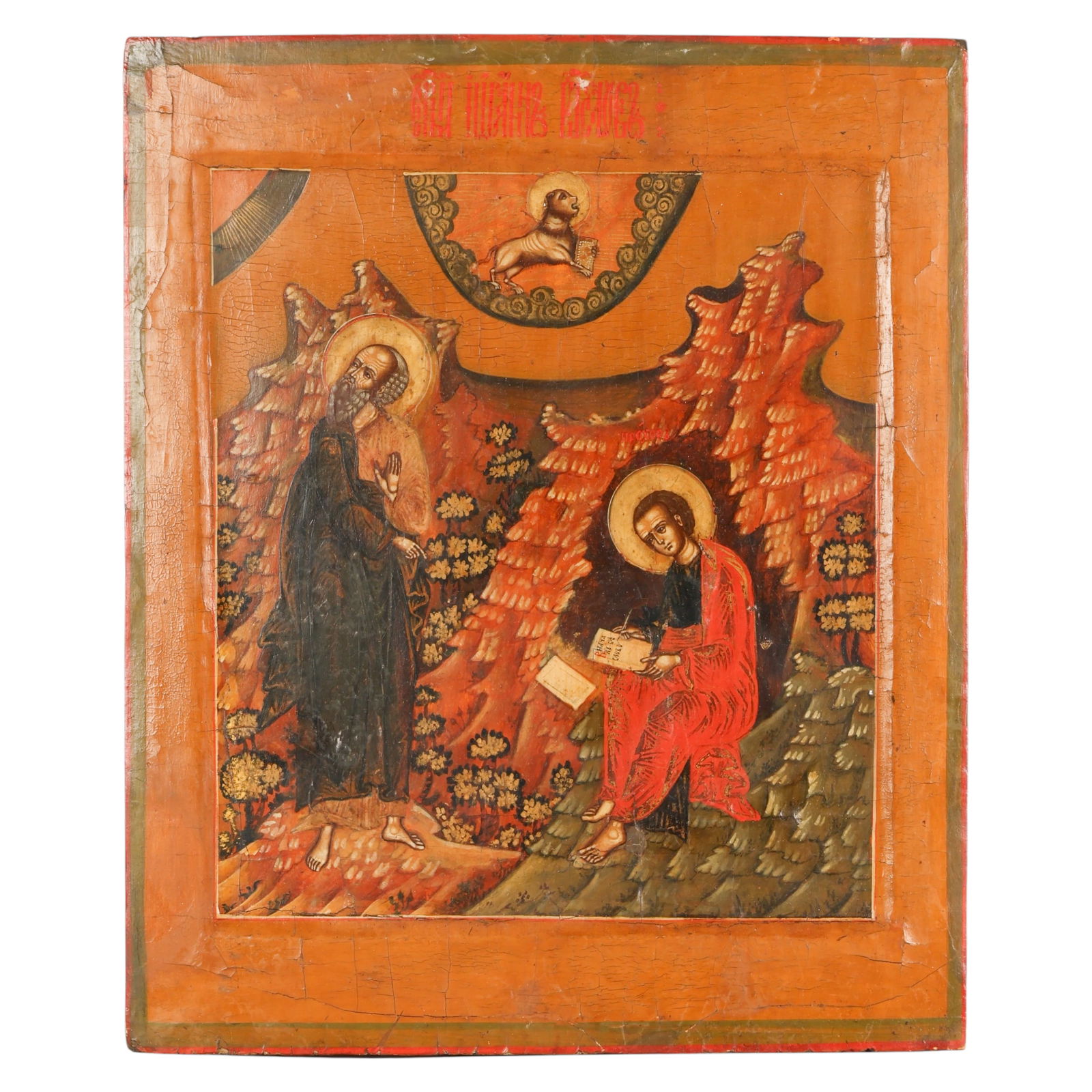 Antique Russian Icon Saint John the Theologian: Russian Orthodox icon, an antique hand painted tempera on wood panel depicting Saint John the Theologian seated upon a rocky outcrop writing in a book, accompanied by his disciple Prokhor standing nea