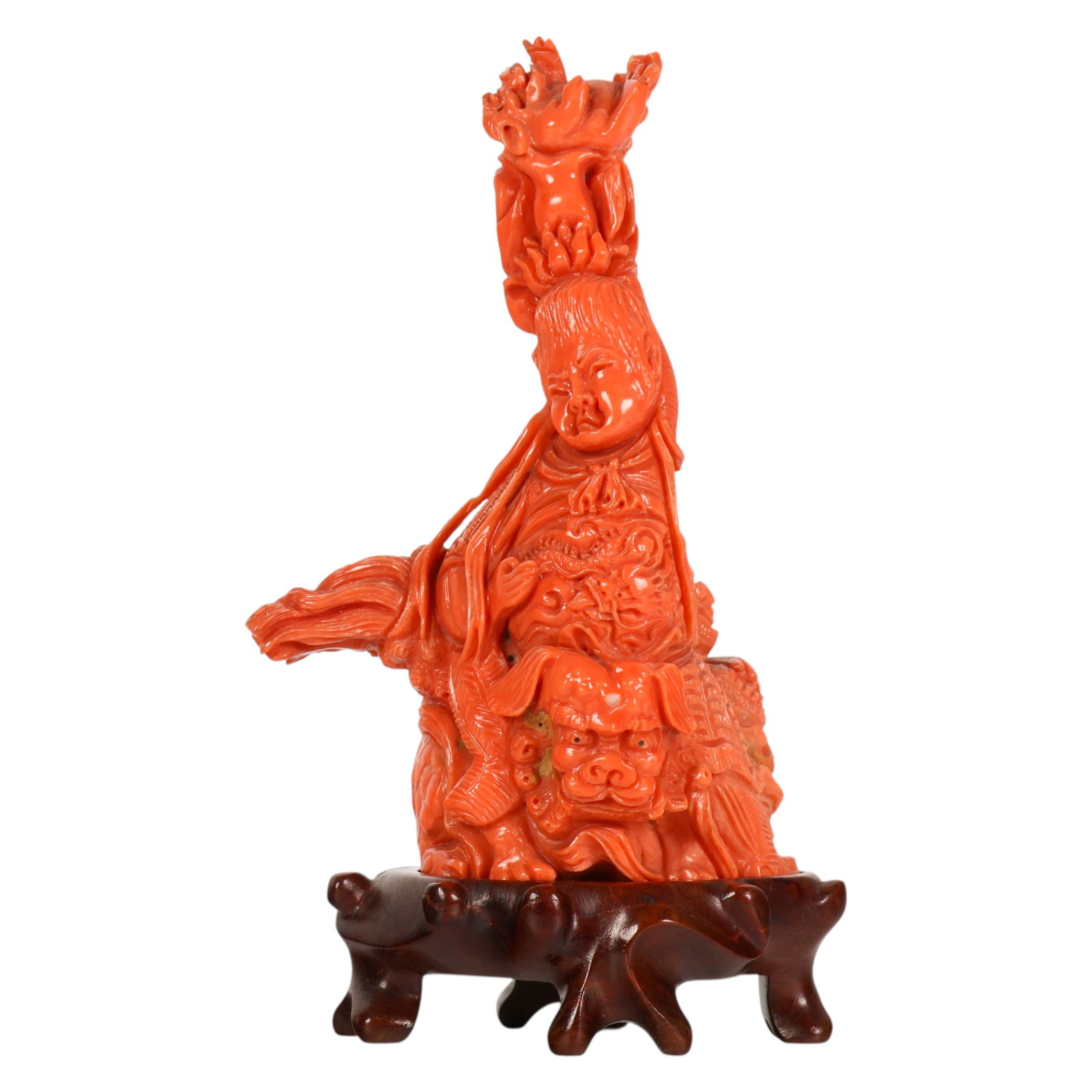 Chinese Carved Red Coral Guanyin on Lion Figure: Chinese red coral, a carved natural coral figural group depicting Guanyin seated atop a stylized lion dog with an additional lion positioned above her head, the bodhisattva shown in flowing robes with