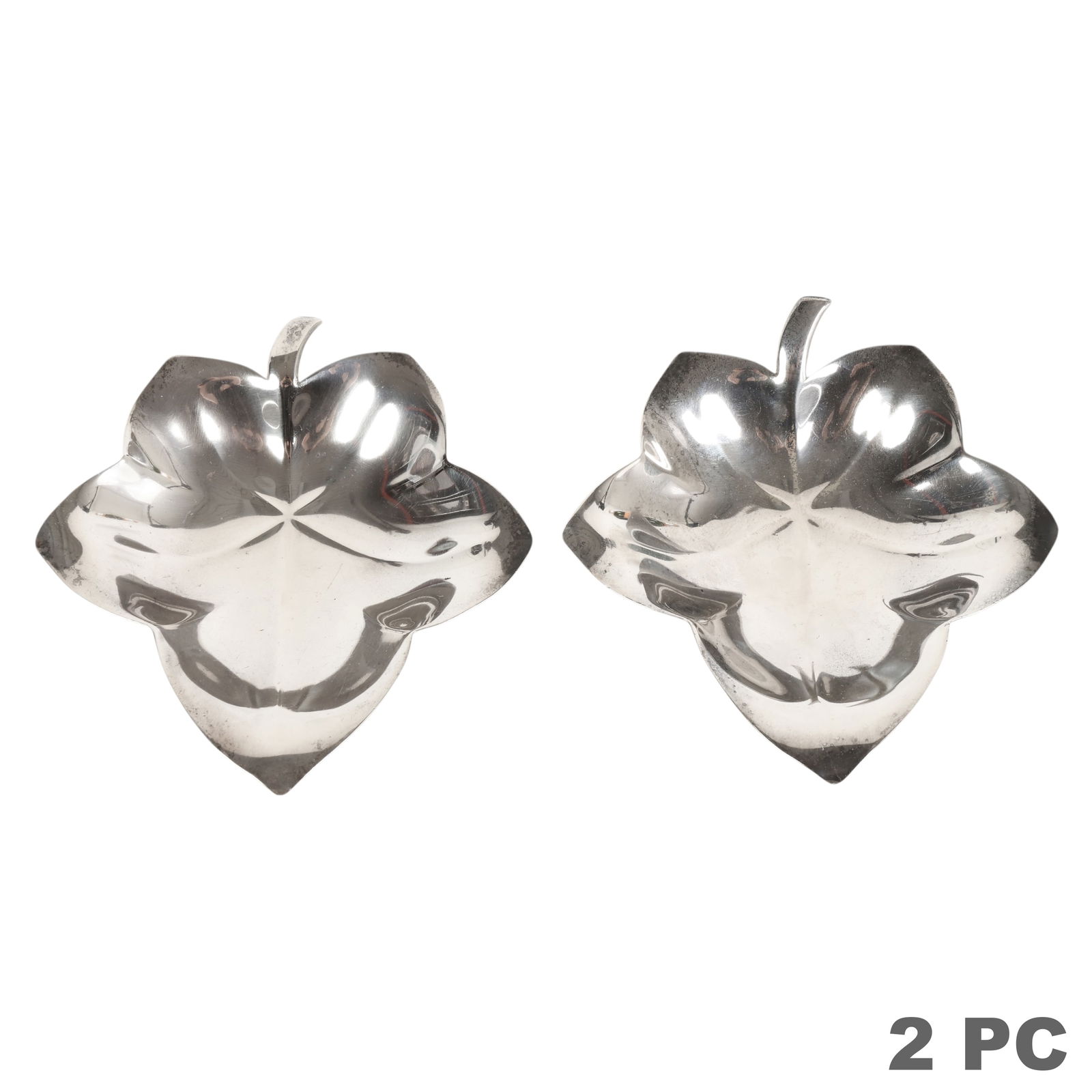 Tiffany & Co Pair Sterling Silver Leaf Dishes 244g: Tiffany & Co, a pair of sterling silver dishes modeled in the form of stylized leaves with naturalistic veining and curled stems, the sculptural forms reflecting elegant organic design characteristic