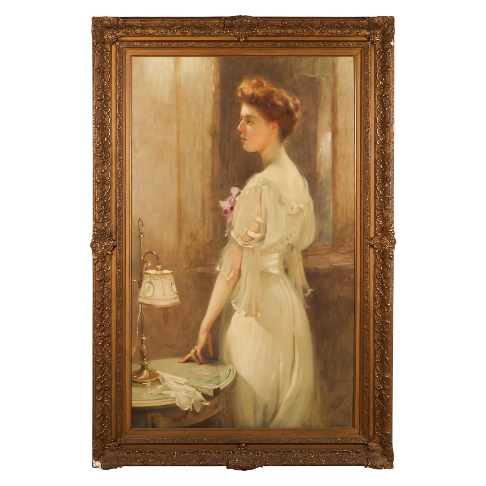 Paul Chabas 1869-1937 Portrait of Woman Painting: Paul Emile Chabas (French, 1869-1937), an antique oil on canvas portrait depicting a woman in a white gown standing beside a table with a lamp, shown in refined profile while delicately holding a smal