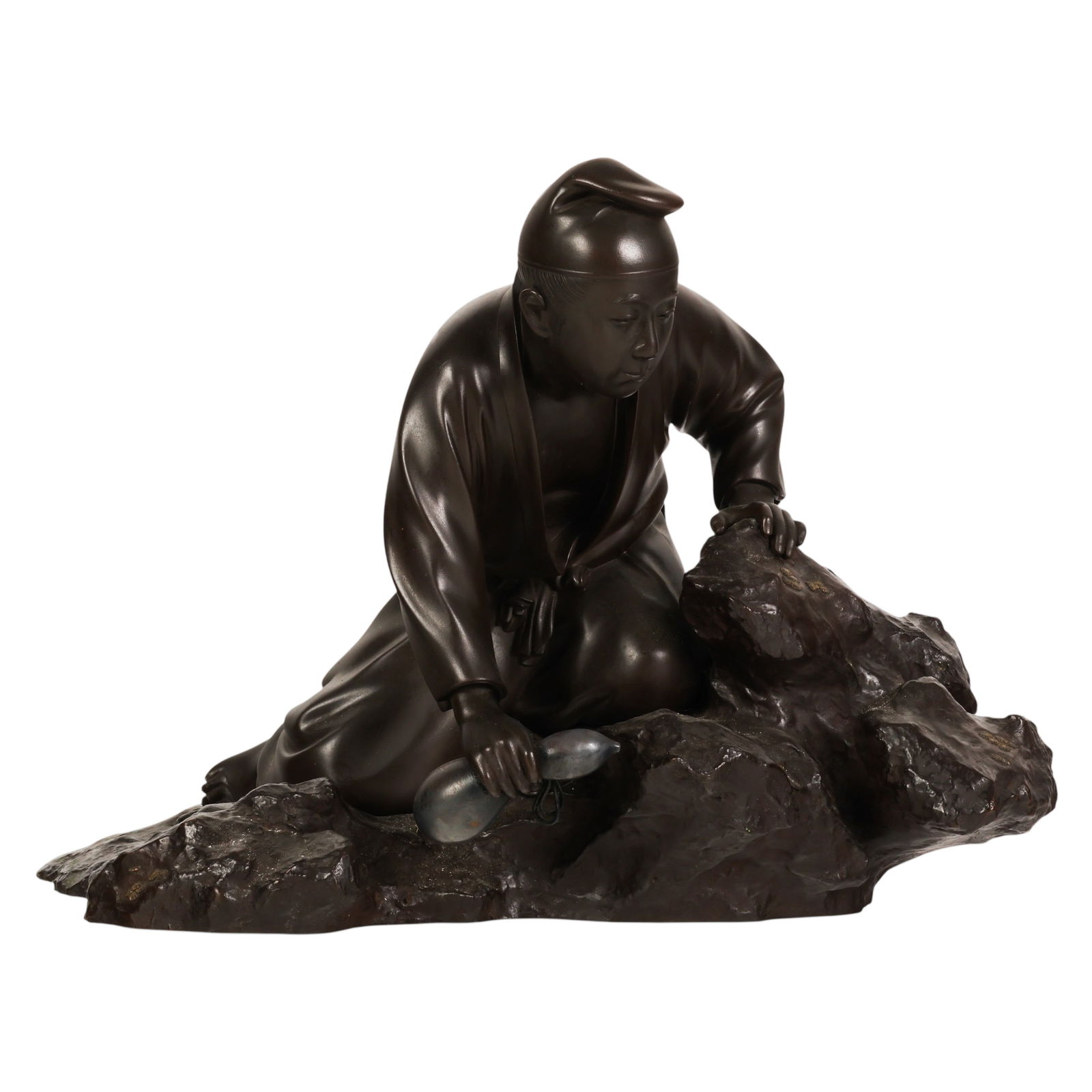 Japanese Meiji Bronze Figural Sculpture SIGNED: Kano Seiun, a Japanese Meiji period bronze statue depicting Chokaro kneeling upon a naturalistic rocky outcrop while collecting water in a gourd, with an axe tucked into his belt. The figure is finely