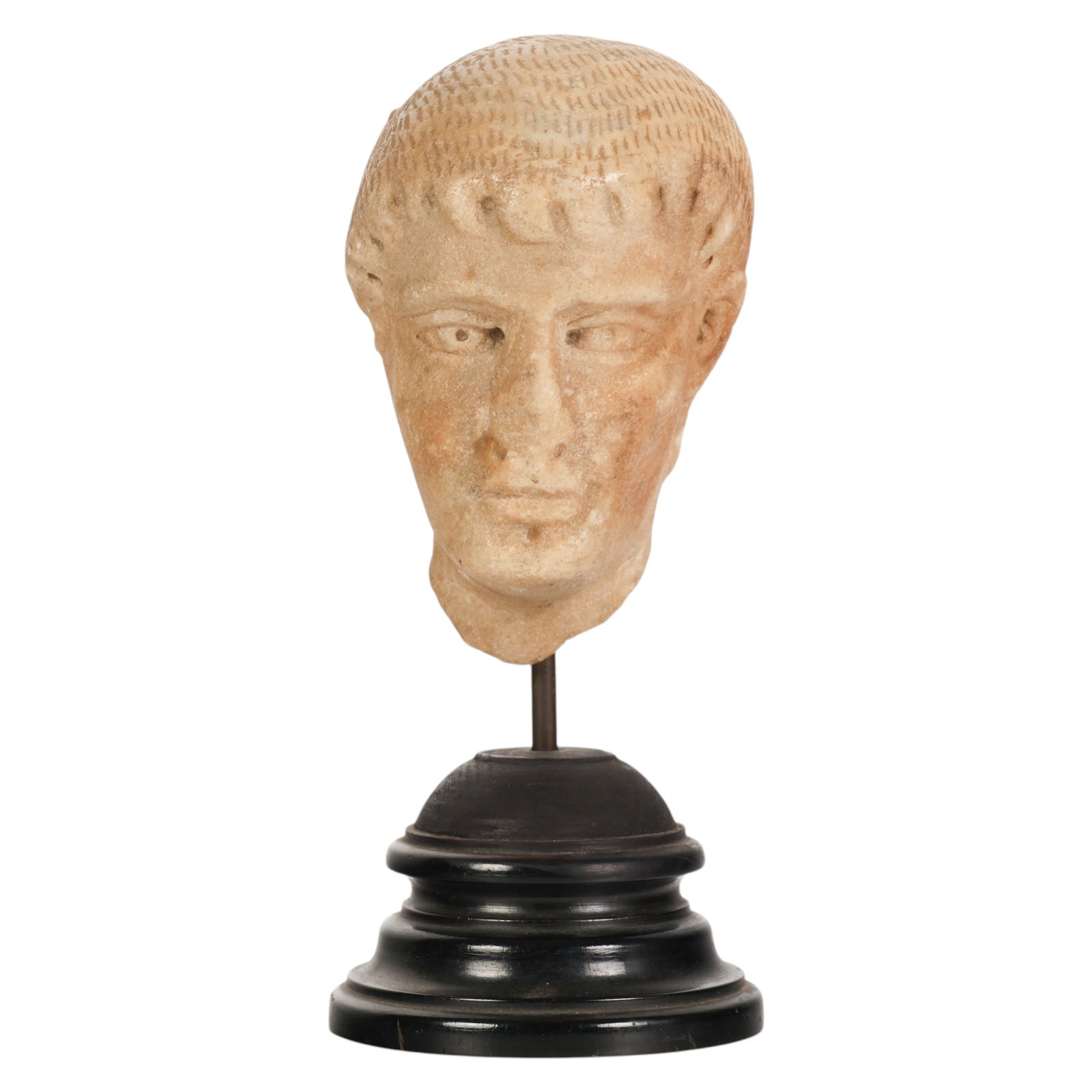 Roman Carved Stone Male Portrait Head Fragment: Roman 2nd Century carved stone, a male portrait head fragment mounted on a black tiered display base, the sculpture featuring defined facial characteristics with incised detailing to the hair, stylize