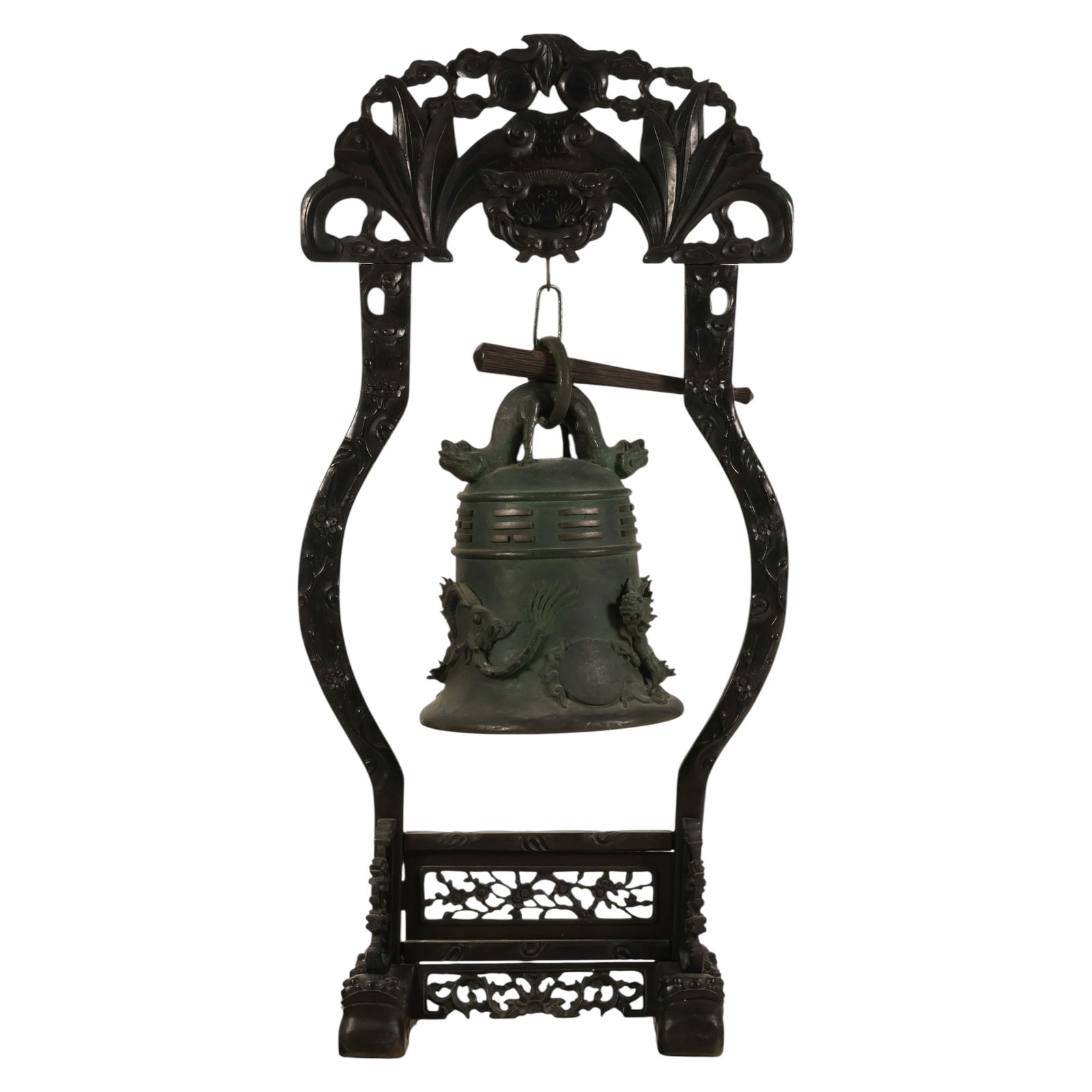 Chinese Bronze Dragon Temple Gong Bell on Stand: Chinese, antique bronze ceremonial temple bell featuring dragon relief decoration and geometric banding encircling the body. The bell is suspended from a carved hardwood stand with openwork scroll mot