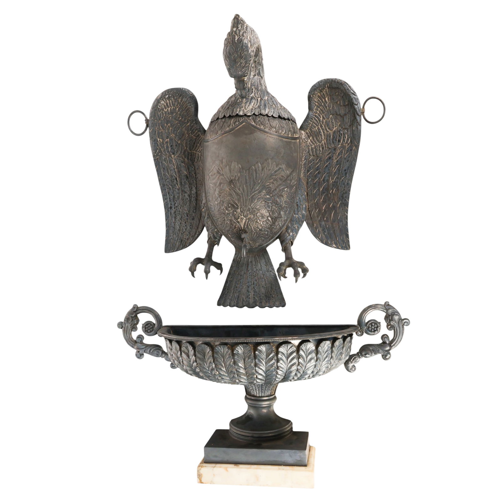 Antique Silver Plated Eagle Motif Lavabo Fountain: Antique European wall hanging silverplate lavabo fountain featuring a cast upper reservoir modeled as a shield shaped spread wing eagle incorporating the spout. The eagle head is detachable and the