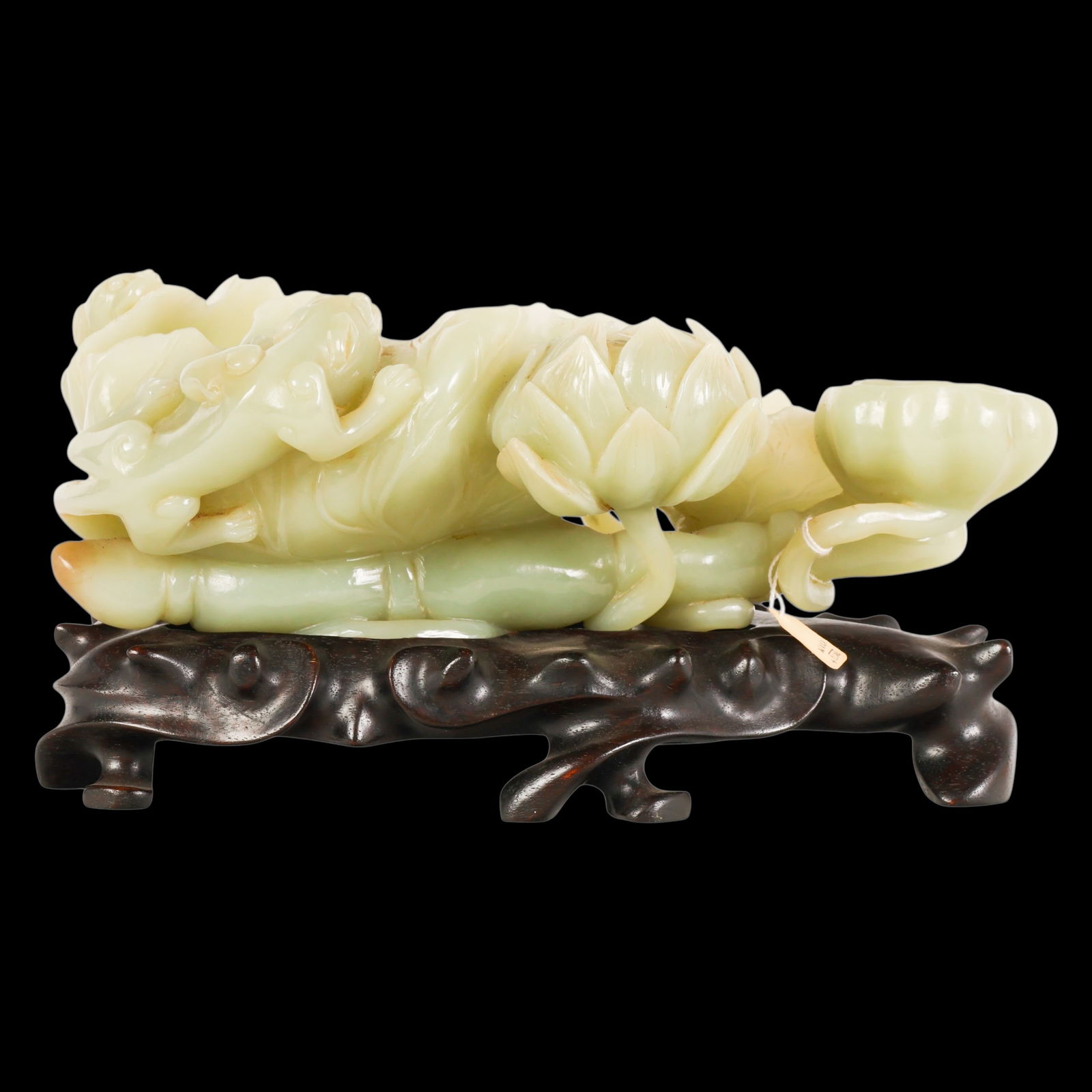 Chinese Celadon Jade Lotus Group of Brush Pots: Chinese 18th Century jade, a brush pot carved in the round as a lotus group comprising blooming flowers, large undulating leaves, lotus pod, and trailing stems issuing from the root, the grouping skil