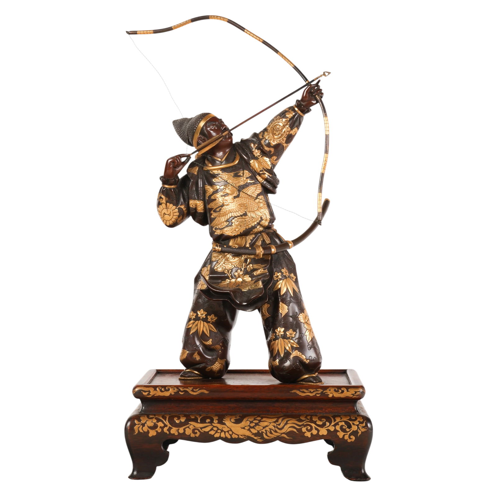 Japanese Miyao Bronze Archer Okimono Sculpture: Japanese, Meiji period bronze okimono depicting an archer drawing a bow dressed in traditional attire with applied gilt decoration featuring floral and avian motifs. The garment bears a Miyao maker