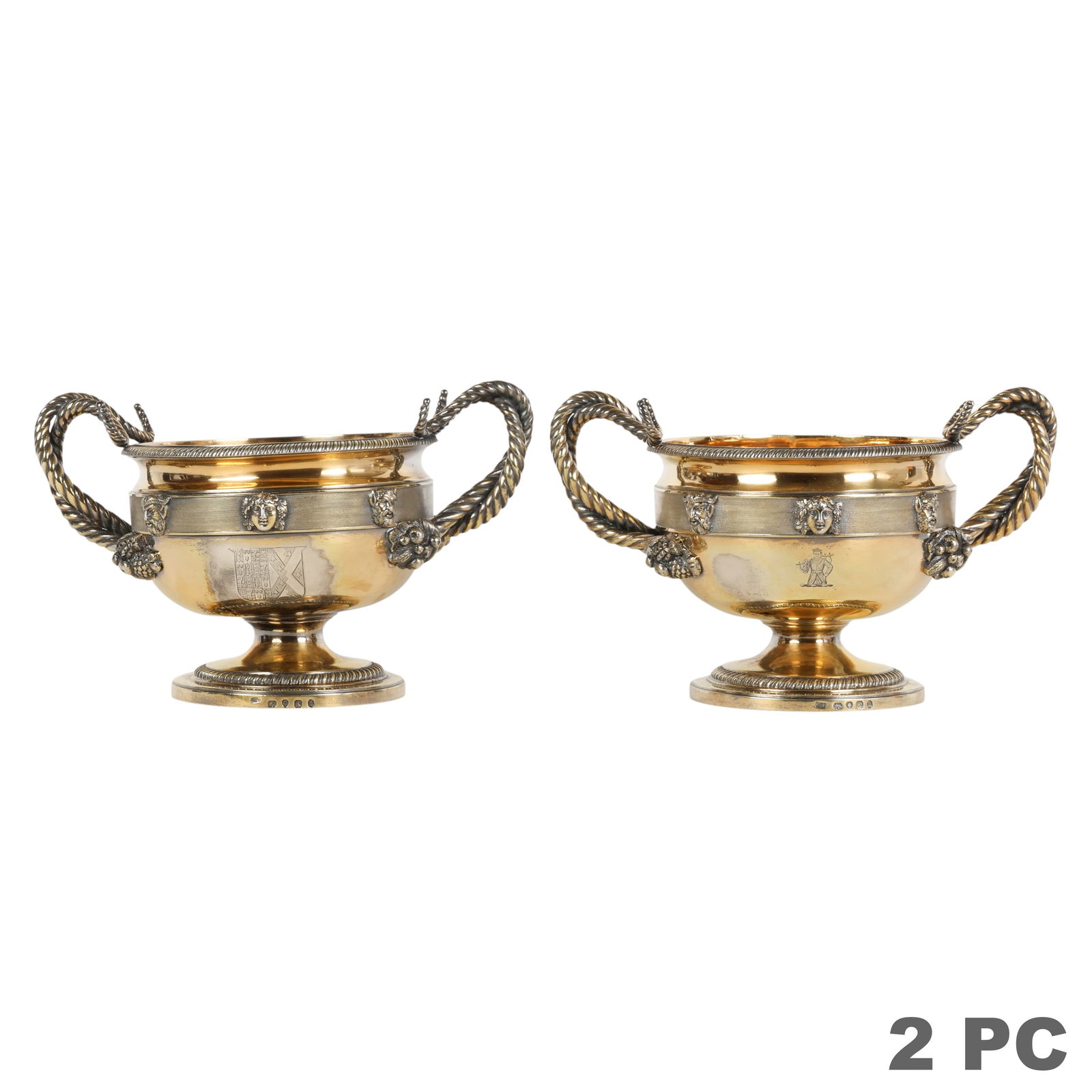Pair of Georgian Sterling Garniture Cups 2,600g.: English 19th Century, a pair of antique sterling silver garniture cups in neoclassical taste featuring gilt interiors and double twisted horn form handles. Each cup is encircled by a band of textured