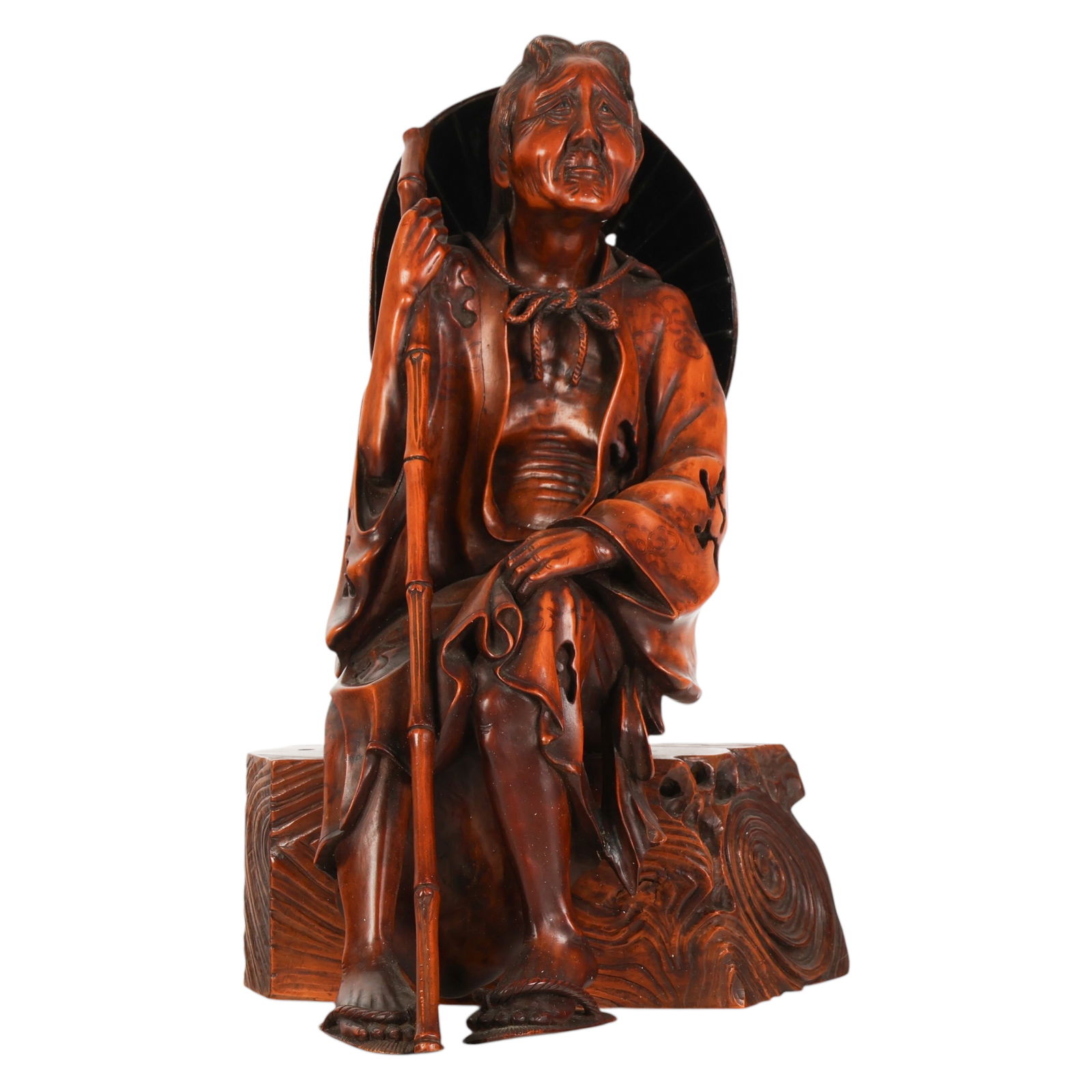 Japanese Carved Wooden Traveler Sculpture signed: Masanori Japanese, a carved and stained boxwood okimono depicting Ono no Komachi as a seated traveler holding a staff and positioned on a naturalistic wood textured base, the figure wearing flowing ro