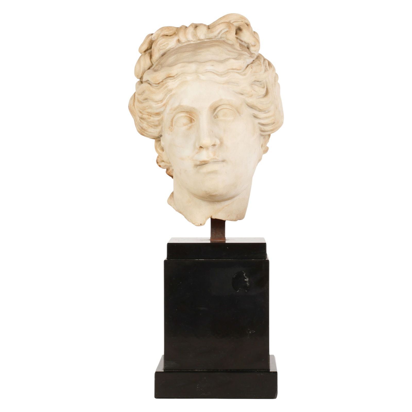 Roman Ancient Carved Stone Female Head on Plinth: Roman probably 2nd Century figure in classical style, the head featuring stylized wavy hair gathered into a knotted arrangement and defined facial features associated with Greco Roman sculptural tradi