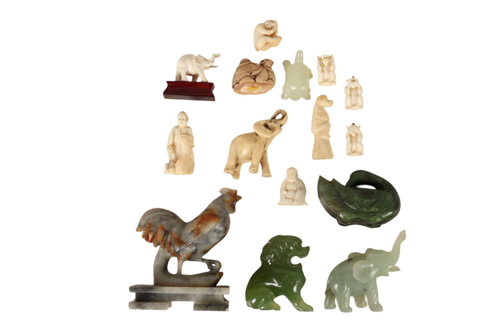 Chinese Carved Green Jade Soapstone Figurines LOT: Grouping of fifteen Chinese miniature carvings including hand carved figures in green and celadon jade depicting a swan or duck a foo dragon lion dog an elephant with raised trunk and a tortoise or tu