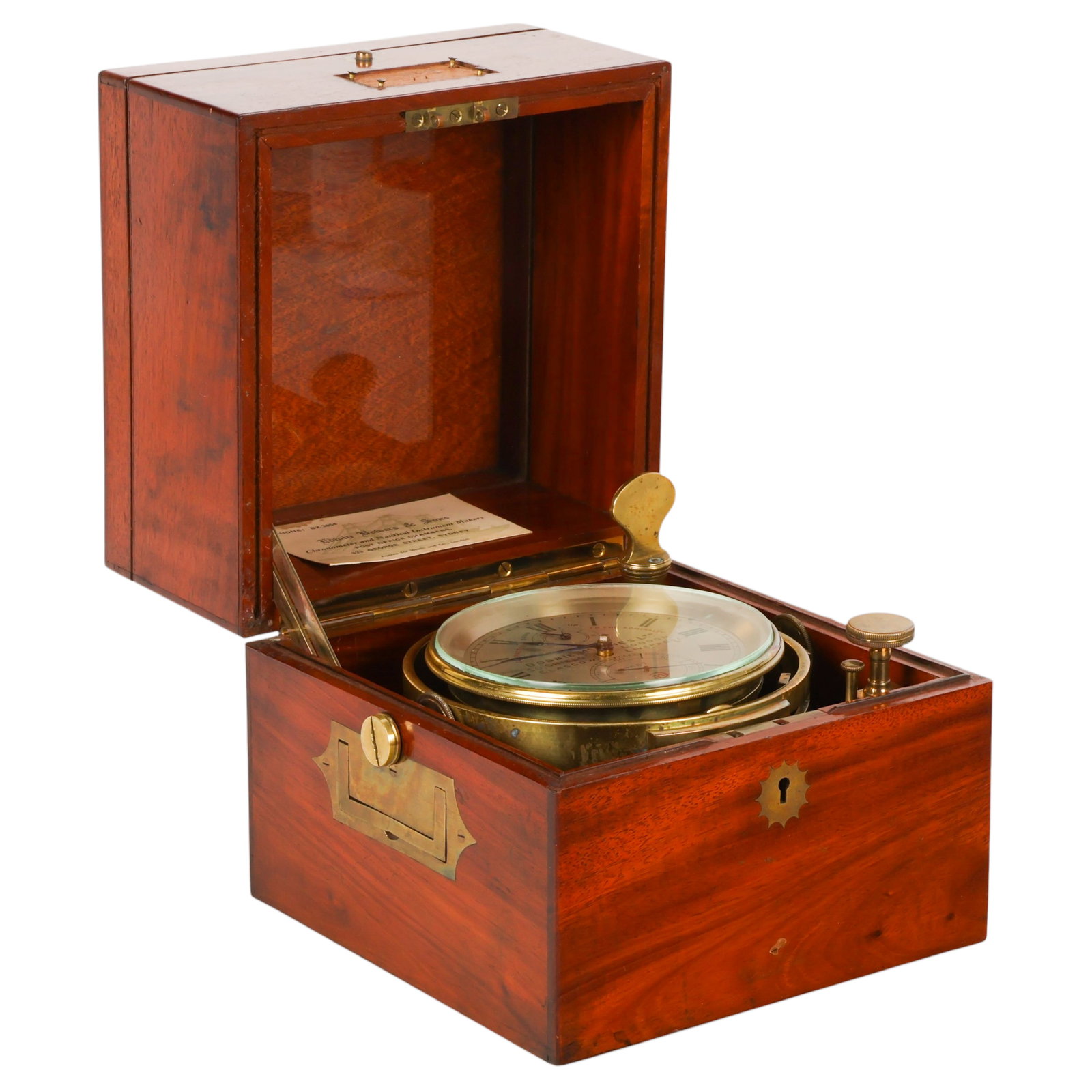 Dobbie McInnes & Co Marine Chronometer in Wood Box: Dobbie McInnes & Co. marine chronometer housed in a fitted rosewood deck box with glazed viewing lid, brass hardware, carrying handles, and a lower accessory drawer. The silvered dial is signed "Dobbi
