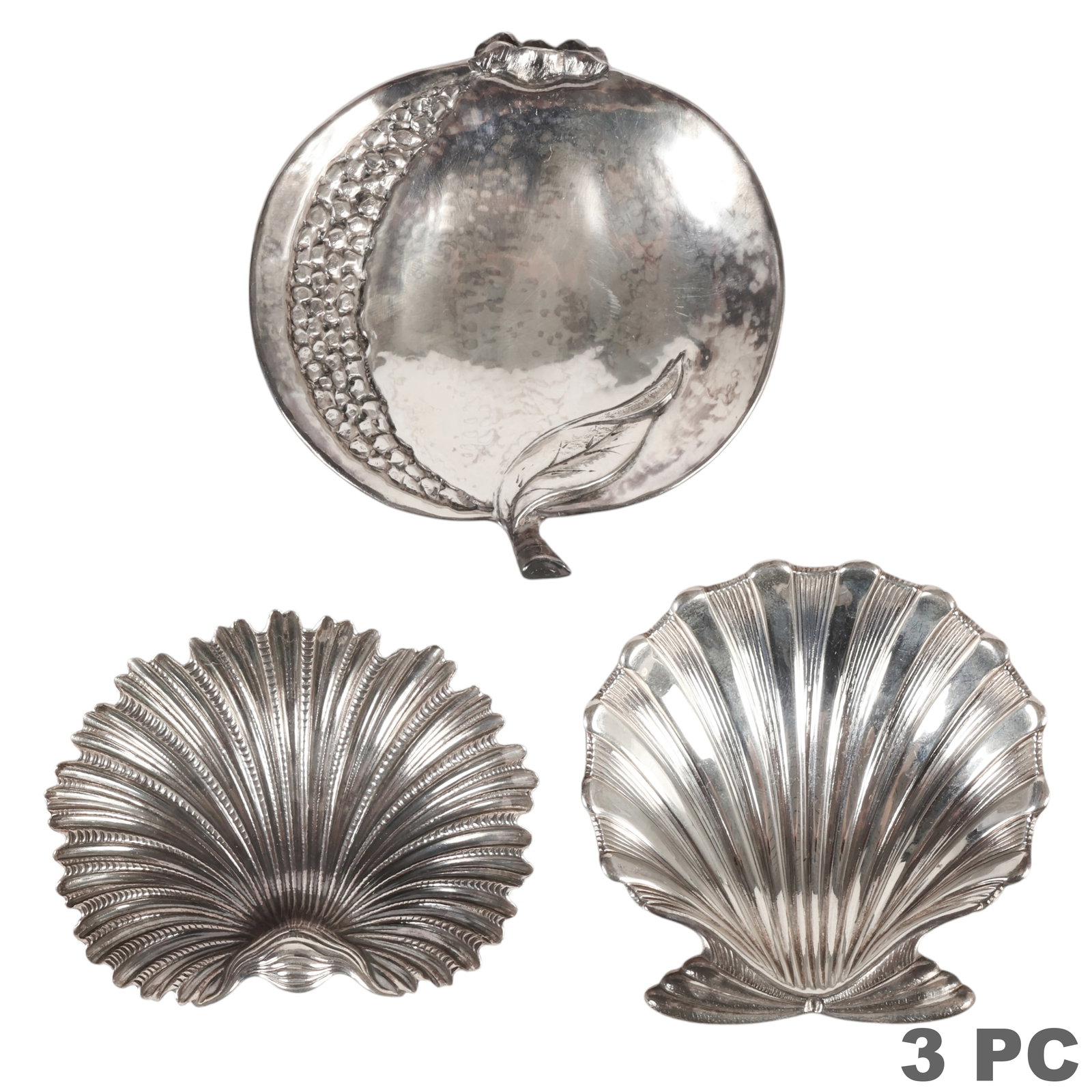 Buccellati Sterling Silver Trinket Tray 3pc LOT: Buccellati lot of three sterling silver decorative dishes comprising one pomegranate-form dish with applied leaf and fruit decoration and two shell-form dishes of differing designs. Each piece is mark