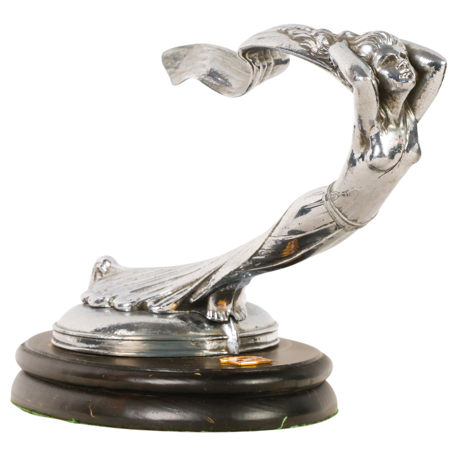 Cadillac Flying Goddess Hood Ornament Display: Cadillac Flying Goddess automobile hood ornament mascot. Chrome-plated figure depicting a streamlined female emerging forward with raised arms, flowing hair, and a sweeping cape, embodying the Art