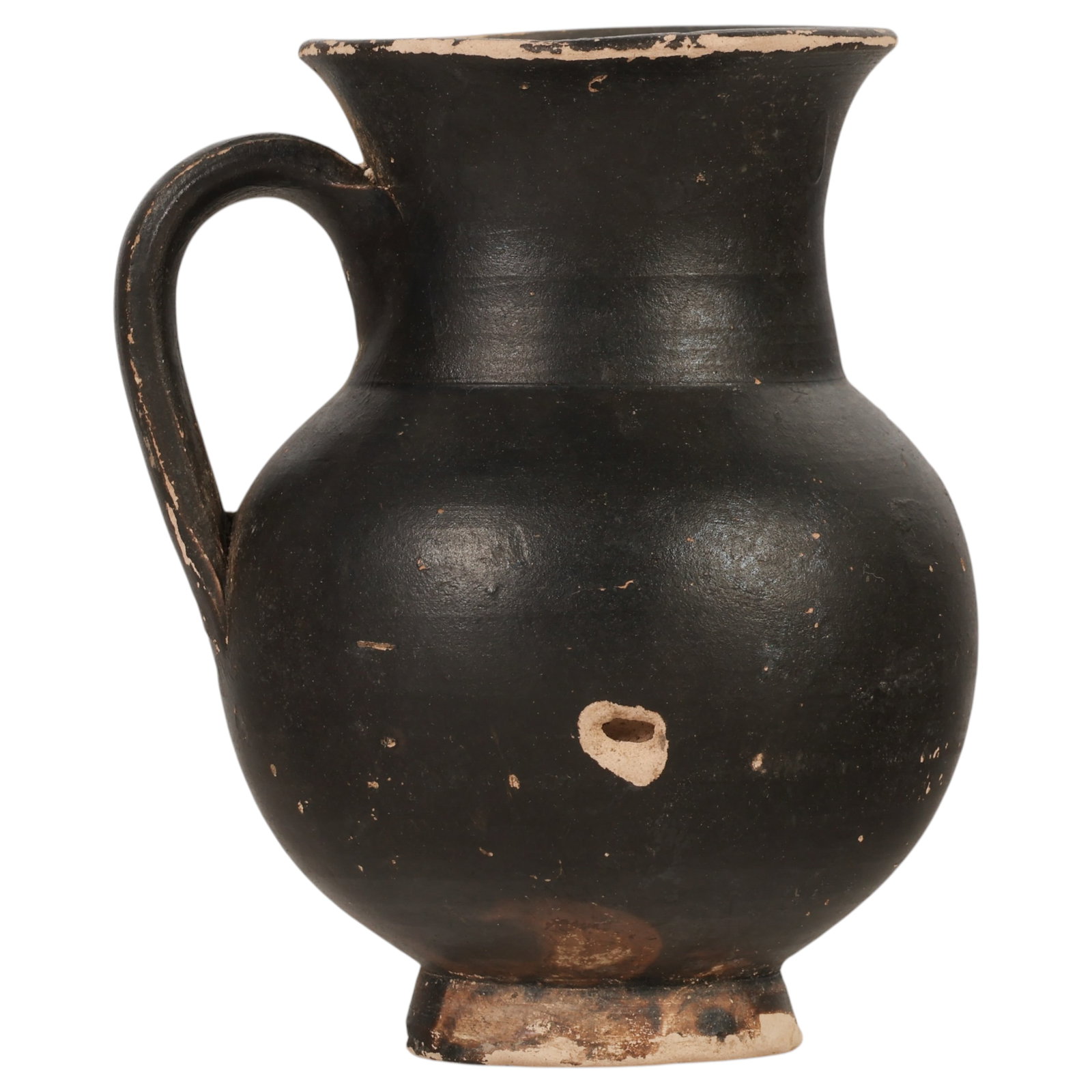 Ancient Greek Style Black Painted Glazed Attic Jug: Ancient style black painted jug having a globular body, flared collar, rounded rim, loop handle, and ring foot. The vessel is covered with a matte black slip over buff earthenware, with the wheel-thro