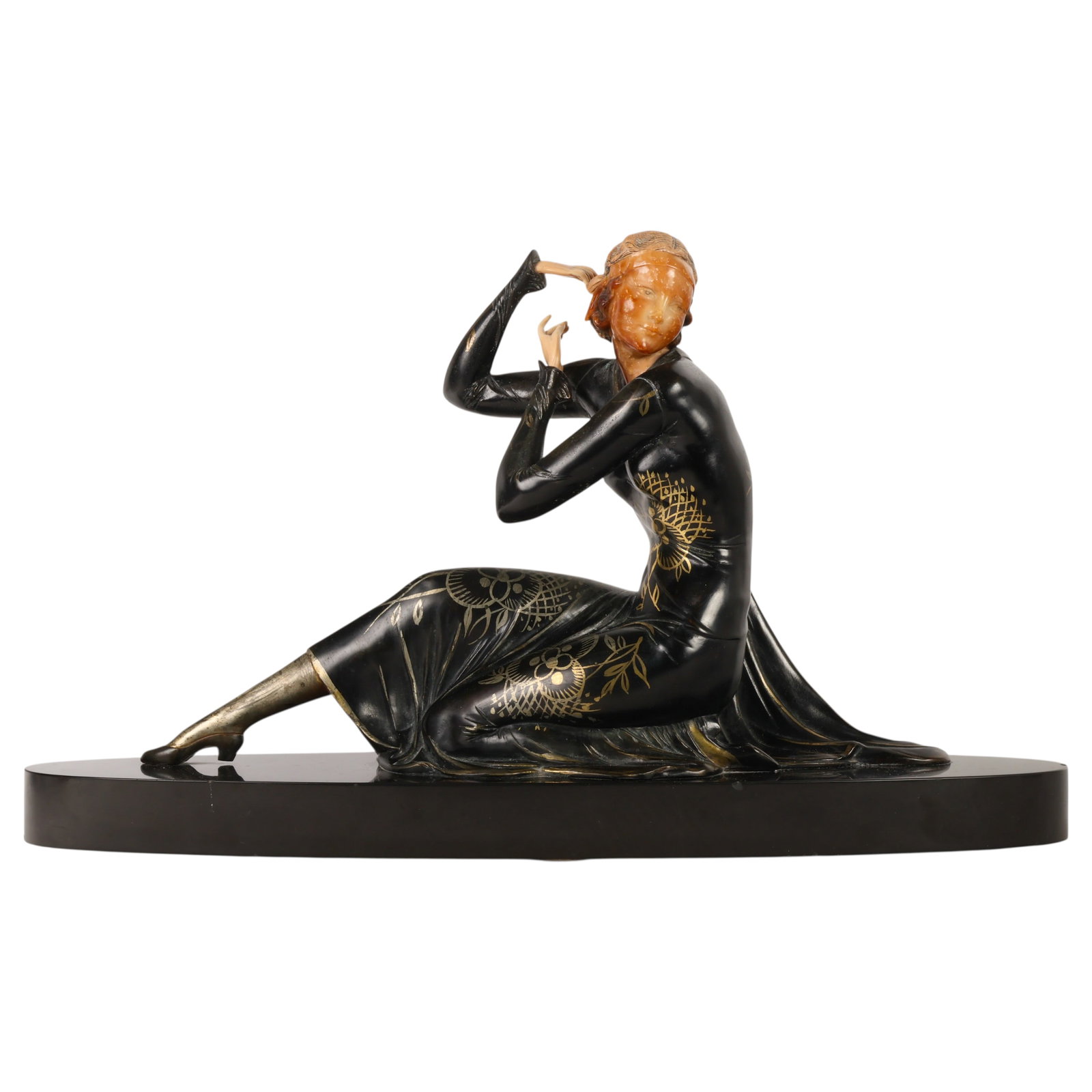 French Art Deco Seated Woman Figural Sculpture: Art Deco style figural sculpture depicting a seated lady wearing a flowing black dress with gilt floral, lattice, and foliate decorations. Resin composition carved head and plastic hands. The elongate