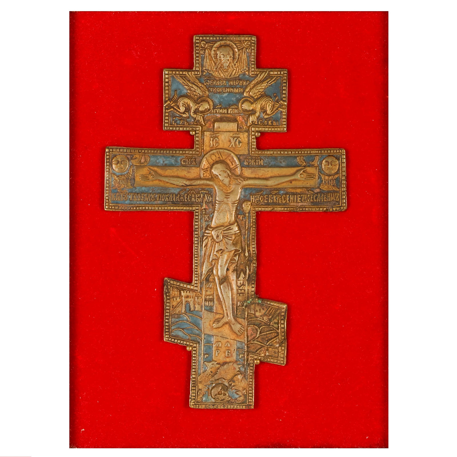Antique Russian Bronze Cross with Enamel Detailing: Russian Orthodox bronze crucifix with polychrome enamel decoration depicting the Crucifixion, mounted within a shadowbox-style giltwood frame lined with red velvet. The cross features traditional Old 