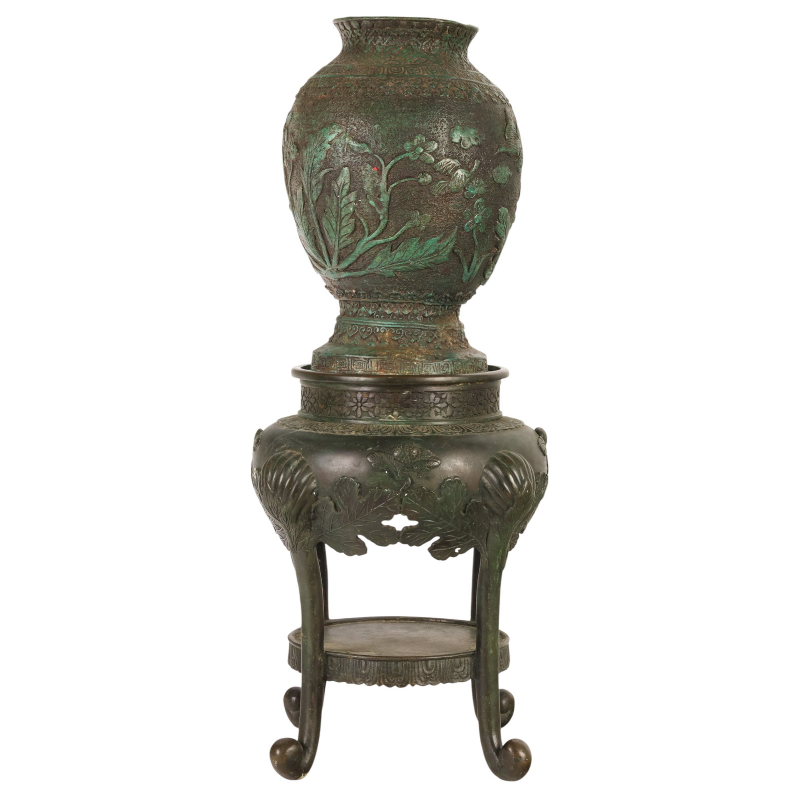 Chinese Bronze Relief Decorated Vase with Stand: Chinese cast bronze baluster-form vase with raised relief decoration depicting flowering branches, birds, and geometric borders, exhibiting a dark brown patinated surface with verdigris highlights. Ac