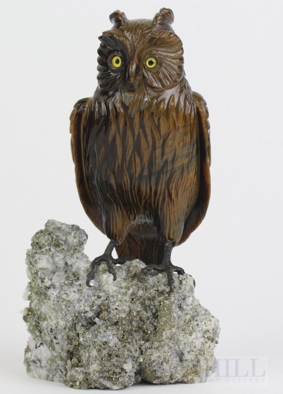 Zadora Gerlof FINE Carved Tigers Eye 5.75" Owl Figurine: Finely carved Owl gemstone figurine by Zadora Gerlof. Carved out of a very nice piece of Tigers Eye gemstone. Wonderful detail with inlaid glass eyes. Sterling silver feet mounted on a natural Quartz 