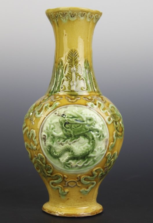 Antique Chinese Sancai Glaze Porcelain Dragon Vase: Antique Chinese porcelain vase. Features a Dragon medallion center with symbol designs. Rich sancai style green and yellow with purple glaze. Six character mark on bottom. Measures 8 1/2" x 4 1/4" In