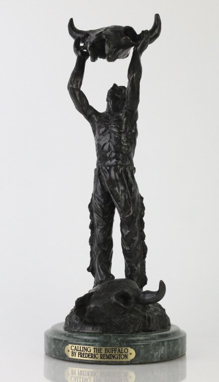 After: Frederic Remington CALLING THE BUFFALO Bronze: Vintage "Calling the Buffalo" sculpture inspired by Frederic Remington. Features a Native American warrior calling into a Buffalo skull. Crafted of cast bronze after the original. Mounted to a green m