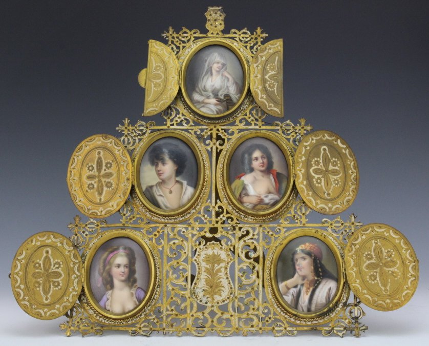 Fine German Berlin 5 pc Porcelain Portrait Plaques: Outstanding example of German Berlin KPM type portrait plaques. Five fine quality oval portrait plaques mounted in an ornate filigree pierced and engraved gilt bronze and enameled frame. Top plaque fe