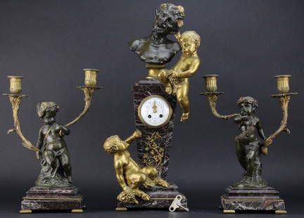 3 piece Clodion Figural Bronze Clock & Garniture Set: Antique French style clock and garniture set signed Clodion, Michel Claude Clodion (1738-1814). Crafted of a deep red marble with powerful graining. Clock features gilt bronze cherub pulling the ear