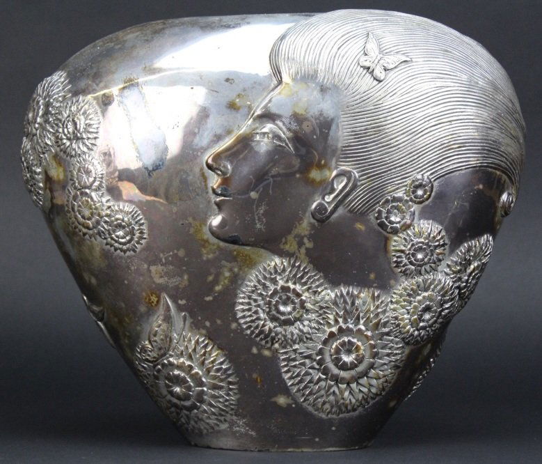 ERTE SHE LOVES ME NOT Silvered Bronze Deco Vase: "She Loves Me Not" sculptural Vase by Erte aka Romain De Tirtoff (1892-1990 Russia). Crafted out of cast bronze with Silver Finish. Depicts a beautiful Art Deco Lady with flowers, butterflies and cupi
