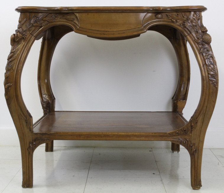 Antique French Inlaid Joan d Arc Art Nouveau Table: Antique inlaid table in the French Art Nouveau Galle style. Features an intricate inlaid top with Joan of Arc. Double tiered design with wonderfully carved Lily and Thistle flowers. Measures 27 1/4" x