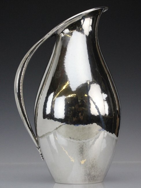 Georg Jensen Johan Rohde 9" Sterling Silver Pitcher: Stunning Danish Modernist pitcher designed by Johan Rohde for Georg Jensen. Crafted of Hand Hammered Sterling Silver. Features a clean line modernist design with hammered finish. Elegant handle with A