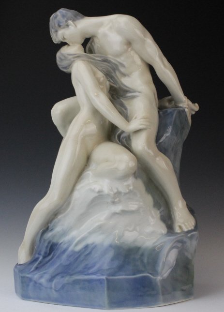 Royal Copenhagen RARE Kissing Nude 18" Porcelain Statue: Large porcelain statue by Royal Copenhagen. This rare figurine features a nude kissing couple in the Art Nouveau style. Man's hands are tied behind his back and they are on a rock with crashing waves.