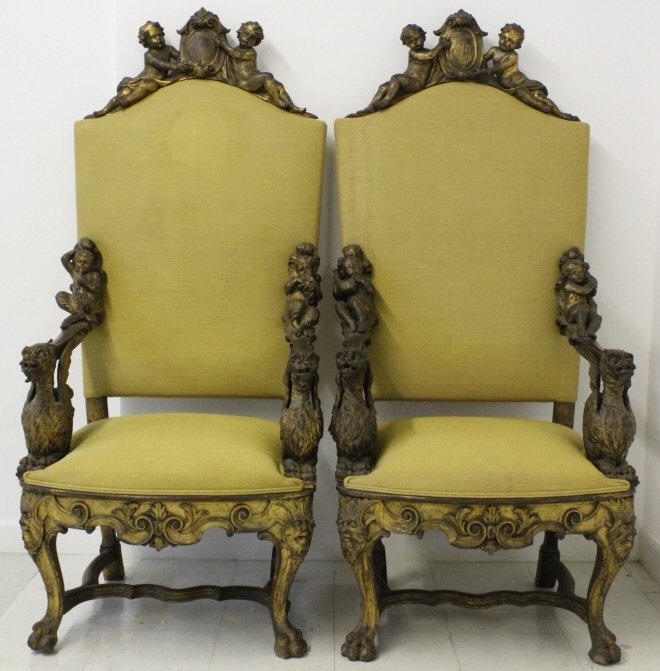 PAIR Antique Italian Carved Gilt Wood Throne Chair: Pair of Antique Late 19th Century Italian gold gilt throne chairs. Oversized with ornate carved design. Features carved Lion hand rests with Cherub and Satyr figural carved tops. Legs are paw feet wit