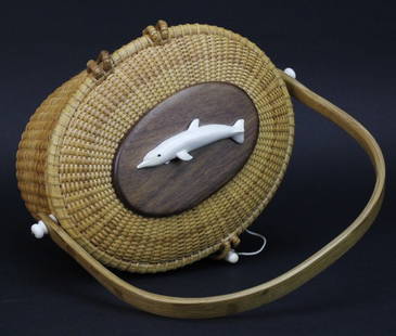 Maureen Reed Nantucket Basket Purse Signed Turner Dated: Signed Maureen Reed Nantucket basket purse. Hand crafted with cherry bottom, walnut top and carved dolphin. Dolphin signed "Turner." Signed on bottom and dated 1987. Measures 7" x 9" x 7". Very good