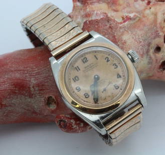 1930's Rolex Two Tone Bubble Back Rose Gold Wrist Watch: Very rare vintage Rolex two tone bubble back pink or rose gold and steel men's wrist watch circa 1934. Ref 3132. Features a bubble back case serial #50.399 topped with a pink gold flat bezel. Rhodium