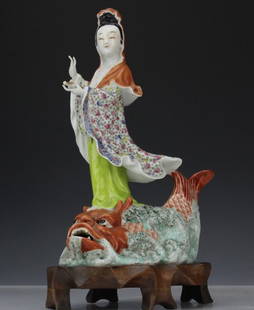 Chinese Porcelain Quan Yin Statue Morris Lapidus Estate: Vintage Chinese export porcelain statue. Features a Quan Yin type figure riding a mythical dolphin type creature. Decorated in the famille rose colors. CHINA stamp on bottom. Comes with a fitted woode