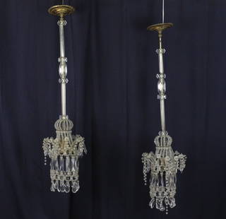 Estate Morris Lapidus 2 Bedroom Brass Glass Chandeliers: Pair of Morris Lapidus designed chandeliers. Constructed of brass, metal and crystal prisms. Each measures approximately 37" in length. From the bedroom of Morris Lapidus personal Miami residence. Pre