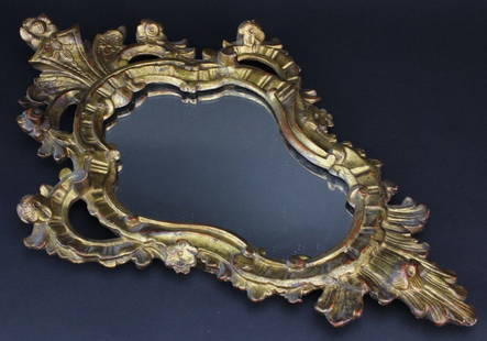 Antique Gold Gilt Italian Mirror Morris Lapidus Estate: Antique Italian carved and gilt wood mirror. Ornate cartouche form design with floral and scroll detailing. From Morris Lapidus' personal Miami residence. Previously installed as part of the Bass Muse