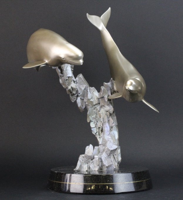 Signed Robert Wyland Beluga Whale L/E Bronze Sculpture: Sold out limited edition "Ocean Dance" sculpture by Robert Wyland (1956- American) Features a pair of Beluga whales crafted out of cast bronze with gorgeous colored finish. Mounted on a dark stone bas