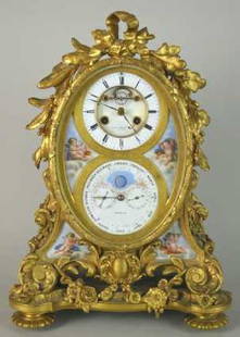 LOUIS XVI STYLE CLOCK: C.1850, By Tiffany, Young Ellis N.Y., Ormolu With Porcelain Cupid Painted Decoration, Time & Strike, Shows Date, Month, Day And Moon Dial, 17"H. 12"W. 7"D.