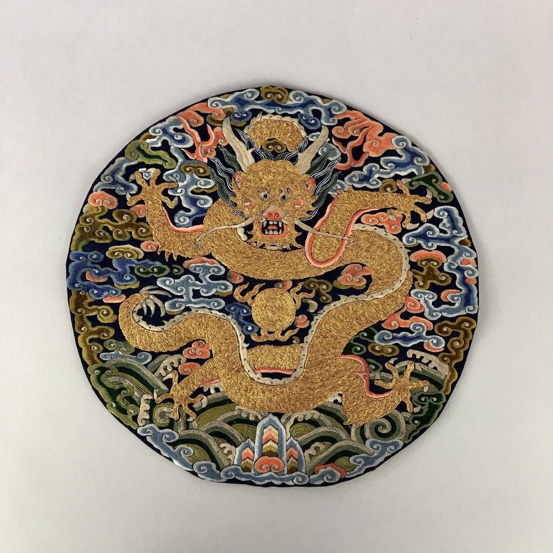 A CHINESE SILK EMBROIDERED DRAGON ROUNDEL (1 of 5)