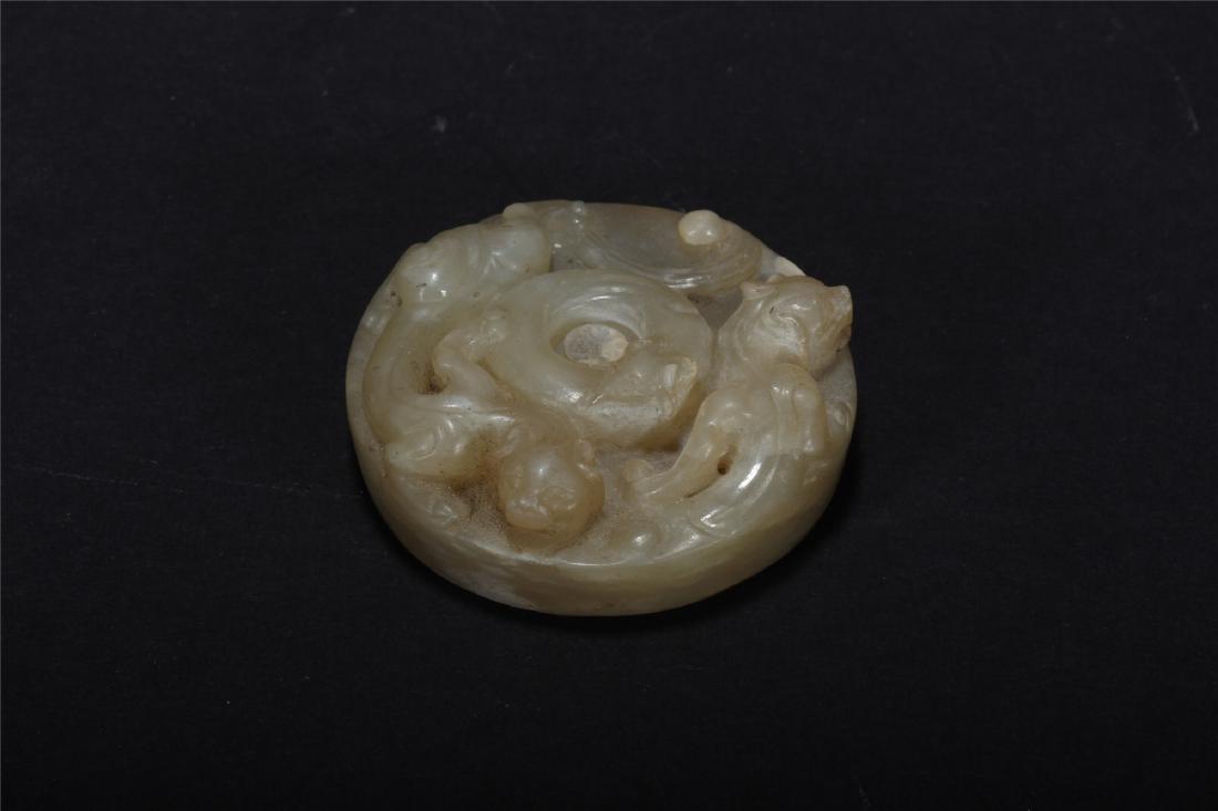A CHINESE ARCHAISTIC JADE SWORD FITTING (1 of 9)