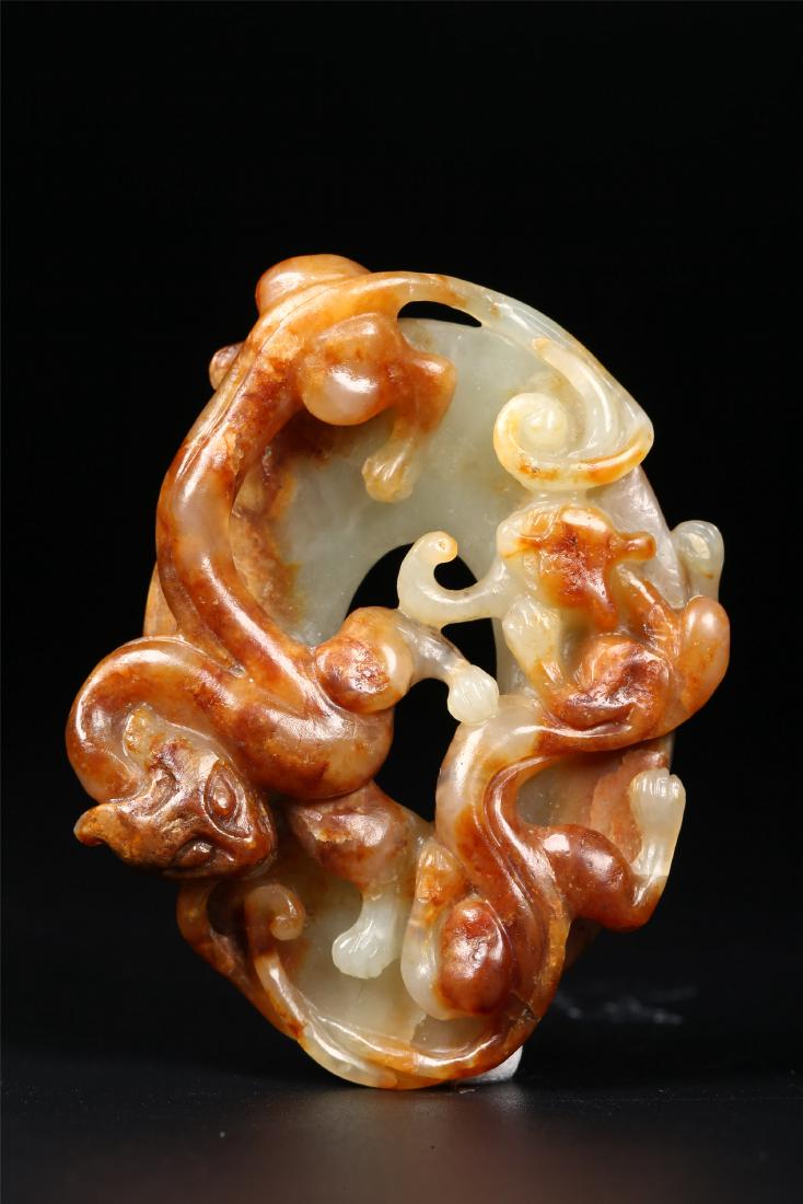 A CHINESE CELADON AND RUSSET JADE PENDANT (1 of 6)