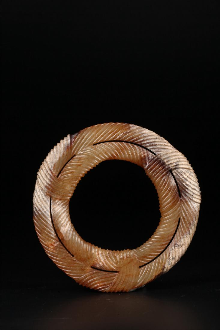 A CHINESE ARCHAISTIC JADE RING (1 of 10)