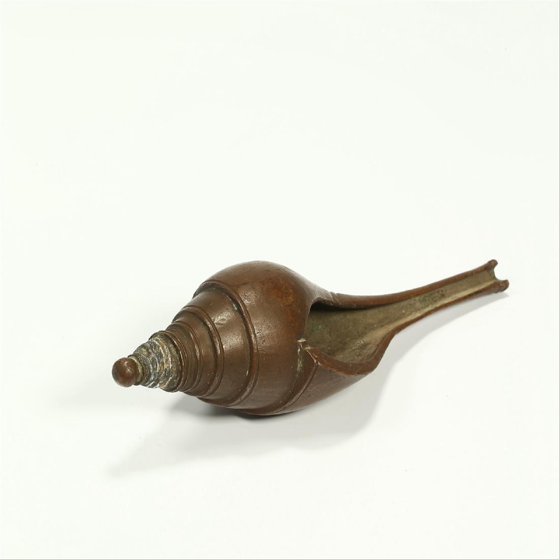 A CHINESE BRONZE MODEL OF A CONCH SHELL: 7 inches long.