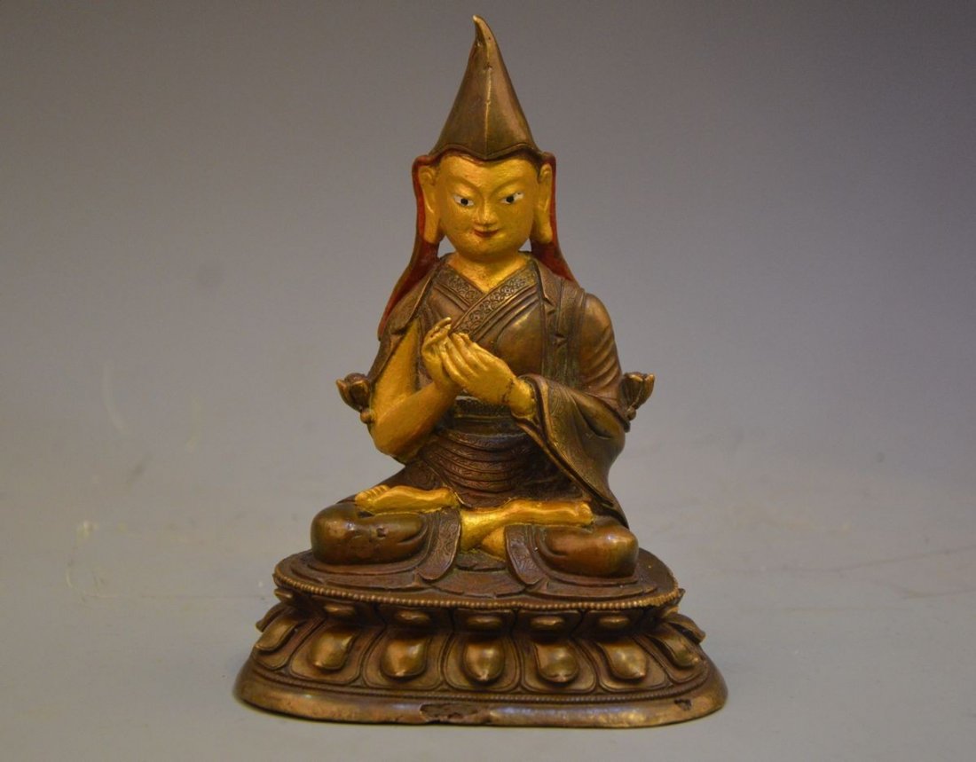 A CHINESE GILT BRONZE AND POTTERY STATUE OF A LAMA (1 of 10)