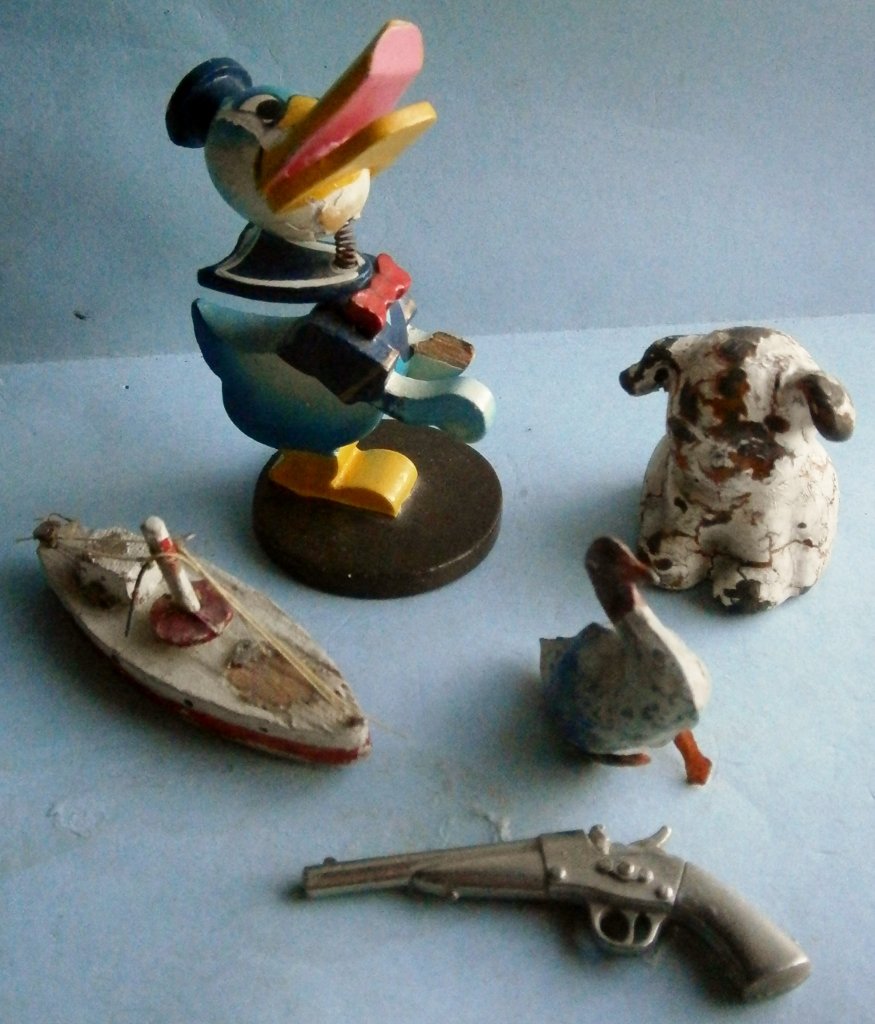 5 small vintage toys: 5 small vintage toys, consisting of a Donald Duck wood toy, missing piece of hand, a Hubley cast iron dog party favor / paperweight, a die cast pistol, 2 1/2 in. long, early hand painted duck, a wood