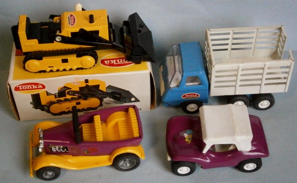 (4) 1960's Small TONKA toys: (4) 1960's Small TONKA toys in never played with condition, one still in box, together with a Tonka Toy Look Book.