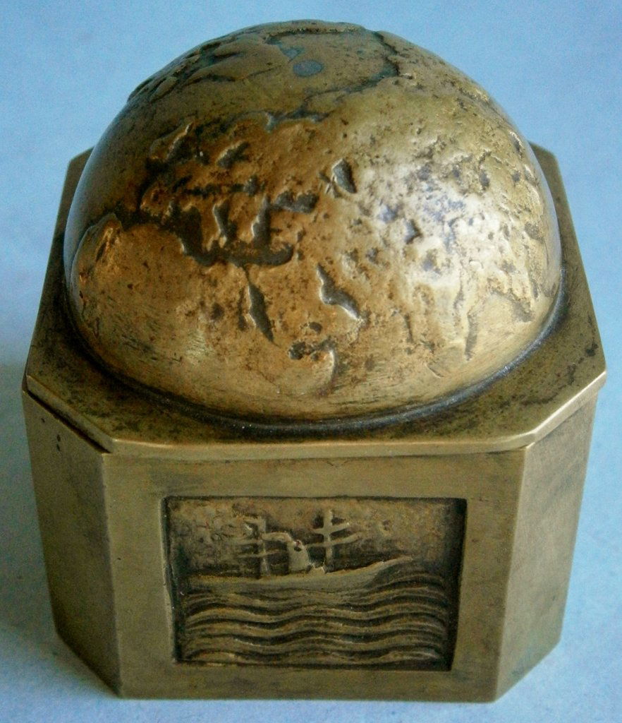 Early Cast Brass Inkwell with Globe Top: Early Cast Brass Inkwell with Globe Top and Image of Steamship on one panel, from the late 19th century or early 1900s, has image of steamship with sails on front panel, half globe on top depicting Eu