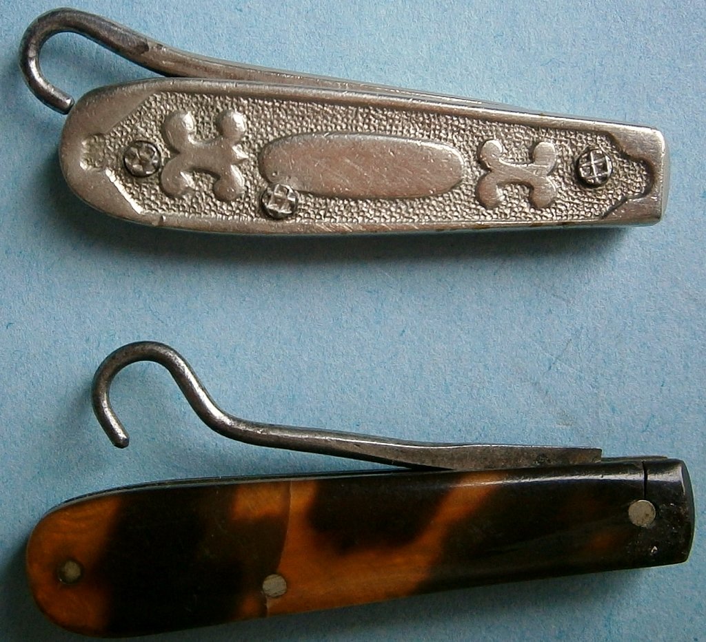 Pair of Antique Folding Glove Button Hooks: Pair of Antique Folding Glove Button Hooks from the early 1900â€™s or earlier, approx. 1 Â¾ in. long (folded), one has a decorated nickel plated handle, other has faux shell handle (piece missi