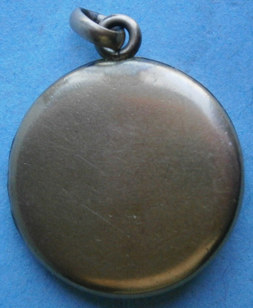 Antique S.B.C. Co. Locket complete with picture covers: Antique S.B.C. Co. Locket complete with picture covers, from the early 1900's, has Star emblem inside cover, 7/8 in. diameter, probably gold filled, does not close properly
