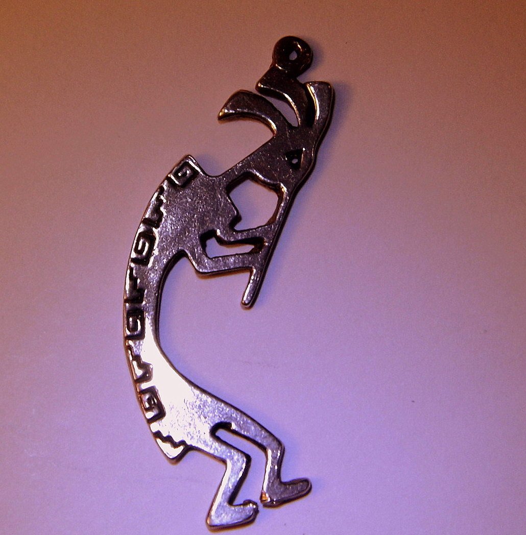 Southwestern Tribal Deity Sterling Charm Kokopelli: Pre-Columbian God of seduction and fertility bracelet or keychain charm. Marked Sterling. Measures 2 inches.